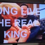 Image of AI-generated video depicting Donald Trump kissing the feet of Elon Musk with a text overlay that reads 'Long Live The Real King.'